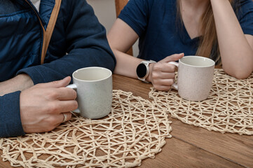 Friends chatting over a cup of tea, a man and a woman couple