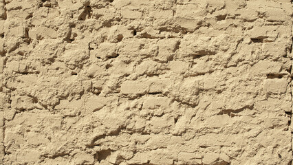 brown background, photo shows brick wall and plaster of building