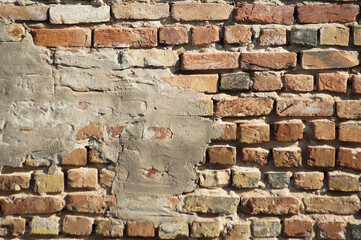brown background, in the photo the texture of an old brick and plaster wall