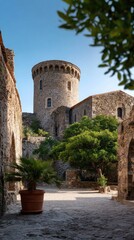 Santa Coloma Church with Round Tower and Ancient Stone Walls Surrounded by Greenery
