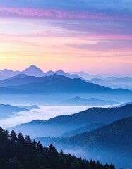 Obraz premium Serene mountain vista at dawn, layers of blue hills fading into the horizon beneath a pink and blue sky. Lush forest lines the foreground