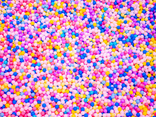colorful ball pit with thousands of multicolored plastic balls at indoor playground entertainment center