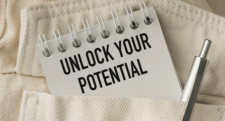 Unlock Your Potential text on open notebook looking out in pocket
