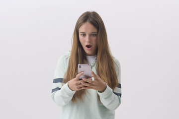 Shocked woman using her smartphone