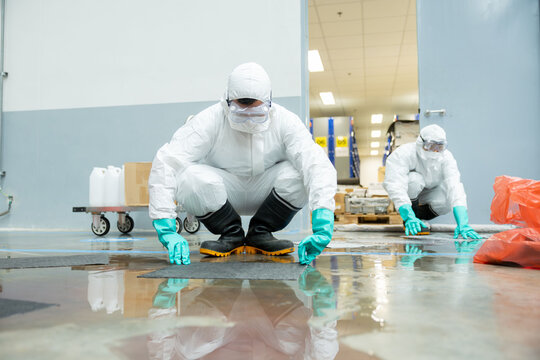 people cleaning chemical leak absorbent