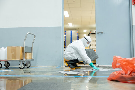 people cleaning chemical leak absorbent