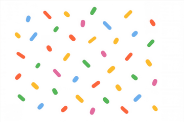 Colorful sprinkles cascading freely, scattered dynamically against transparent surface, highlighting bakery decoration and culinary creativity