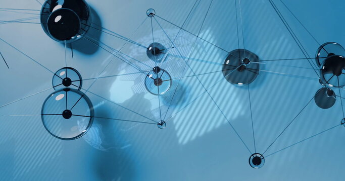 Displaying glass sphere network forming web in blue background, with metallic nodes, rods and wires