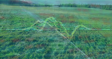 Displaying multicolored telemetry graph overlay covering aerial green landscape, with gridlines