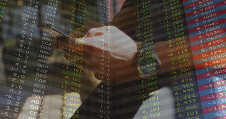 Businessman wearing dark suit striped tie holding smartphone in trading floor, with ticker overlay