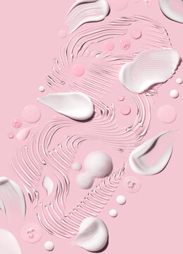 samples of cosmetic care products smear of cream and gel texture on a light pink background, moisturizing and skin care concept