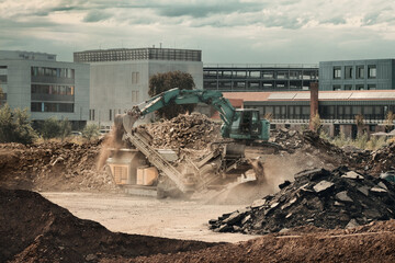 Construction site with excavator and conveyor at work. Industrial action with machinery and dust in...