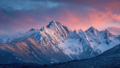 Obraz premium Majestic snow-capped mountain range at sunrise