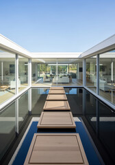Modern courtyard with floating stepping stones over water
