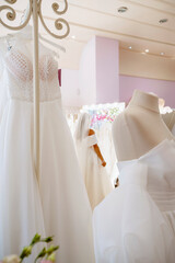 Bride standing in front of mirror trying on dress in atelier
