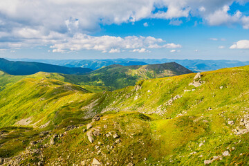 Green mountains and hills landscape with blue sky, valley in mountains landscape