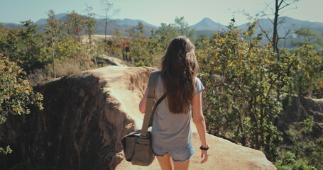 Tourist girl explore desert canyon in Chiang Mai. Female relaxes in Pai Canyon Kong Lan enjoying...