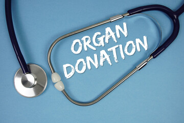 Organ Donation text with stethoscope on blue background