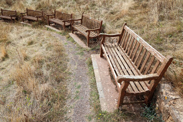 Fototapeta premium Row of wooden benches on the coastal path outside Sidmouth, East Devon