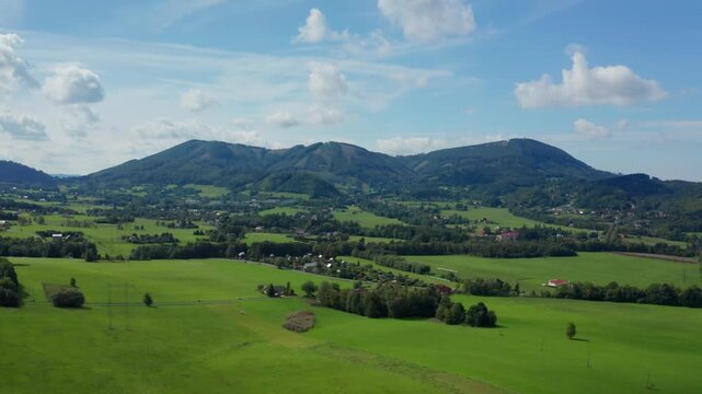 Dolly drone shot of czech small village and fields with beskydy mountains