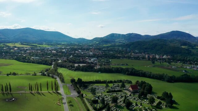 Dolly drone shot of czech small city with beskydy mountains