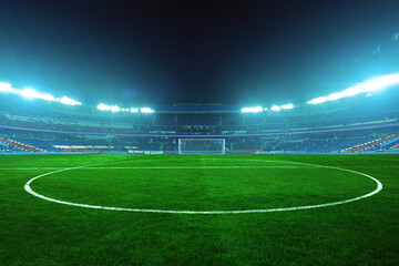 Illuminated beautiful football stadium at night with green field and empty stands, ready for an exciting match under bright blue floodlights. Sports tournament, concept. World Championship Final. © alones