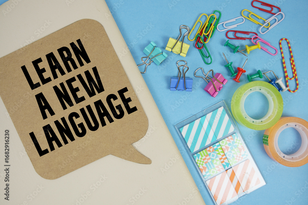 Poster learn a new language text with stationery on cover notebook background
