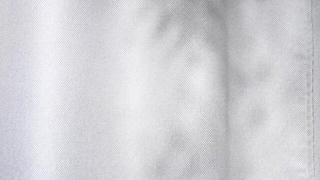 Smooth white fabric shadow creating gentle waves, offering an elegant background for backgrounds and textures, designs minimalist enhancing video 4k