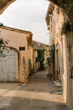Fototapeta Cozy street of old Provençal town in soft sunset light, romantic Mediterranean atmosphere.