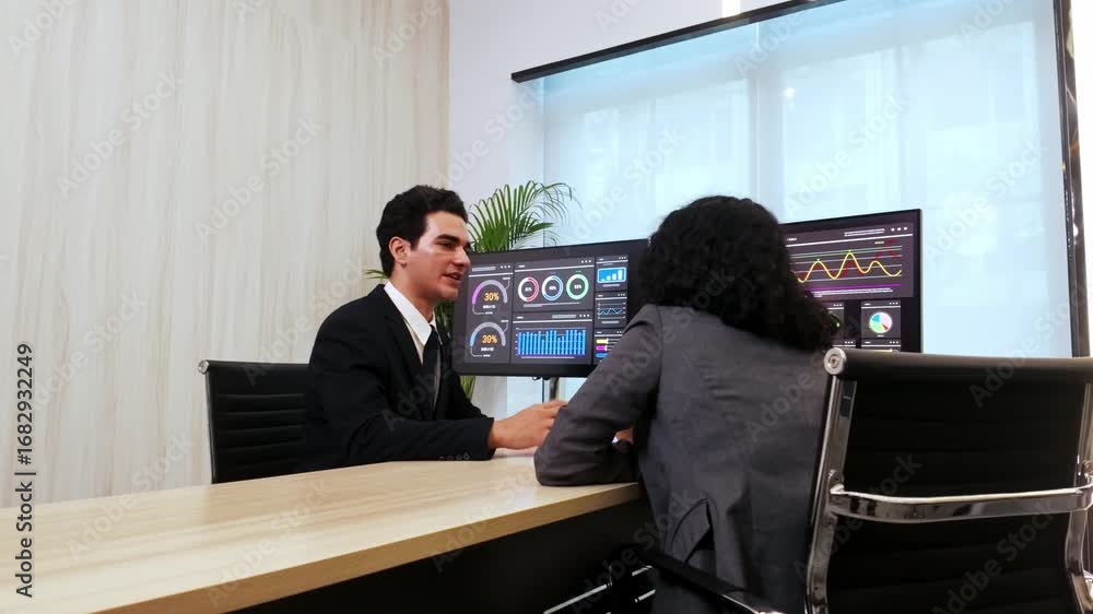 Poster two professionals in modern office review analytics on dual computer monitors with dashboards and ch