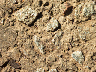 Rough Stone and Dry Soil Surface.