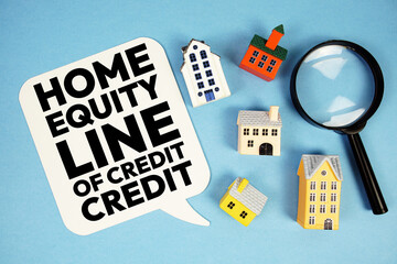 HELOC Home Equity Line Of Credit text with house models on blue background