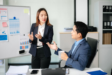 Two busy happy professional business man and woman executive leaders team using laptop working in office