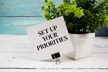 Set Up Your Priorities text written on paper card on wooden background