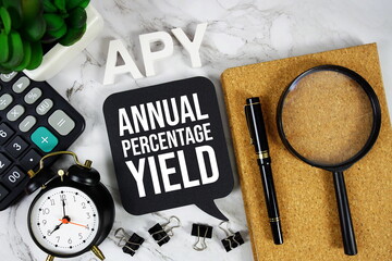 APY - Annual Percentage Yield acronym with calculator, alarm clock and magnifying glass, business...