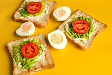 Breakfast consisting of toast with avocado and eggs. Healthy breakfast.
