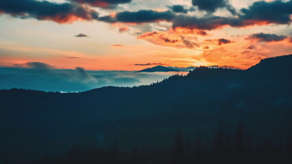 A breathtaking timelapse captures the sunset in the Carpathian Mountains, showcasing vibrant colors illuminating the clouds and valleys below.