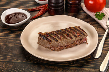 Grilled beef striploin steak with sauce