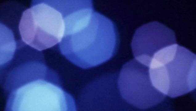 Abstract Blue Bokeh: Soft and dreamy blue bokeh lights dance across a dark backdrop, creating an enchanting ambiance filled with elegance and sophistication.