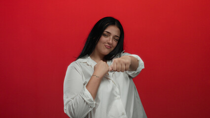 Young plus size woman boxing with confidence against a bold red background, focusing on empowerment...