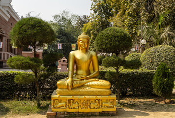 holy golden buddha statue sitting in lotus meditation position at outdoor