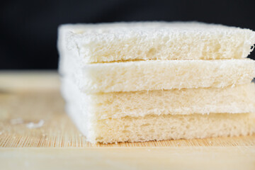 Fresh, soft white sandwich bread slices stacked on a wooden surface, perfect for quick breakfast, delicious lunch, or healthy family snack preparation