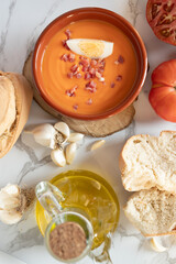 Traditional Spanish cold soup salmorejo served with boiled egg, ham, bread, tomato, garlic and olive oil