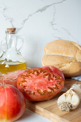 Ingredients for preparing salmorejo, tomatoes, bread, garlic and olive oil