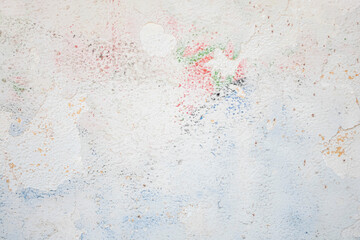 Peeling plaster and paint on the wall as a neutral, calm abstract background.
