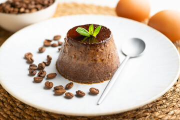 Homemade chocolate and coffee flan decorated with fresh mint. Traditional egg recipe.