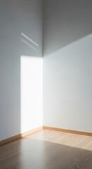 Sunlight casting soft shadows on empty white room corner isolated on white background