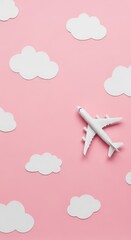 Miniature airplane flying among pink sky and fluffy clouds background
