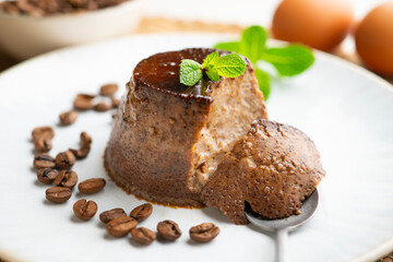 Homemade chocolate and coffee flan decorated with fresh mint. Traditional egg recipe.