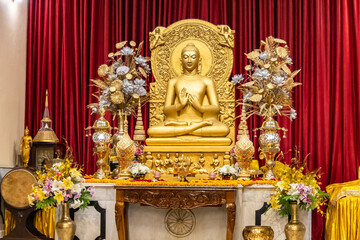 isolated holy statue of golden buddha at monastery at indoor